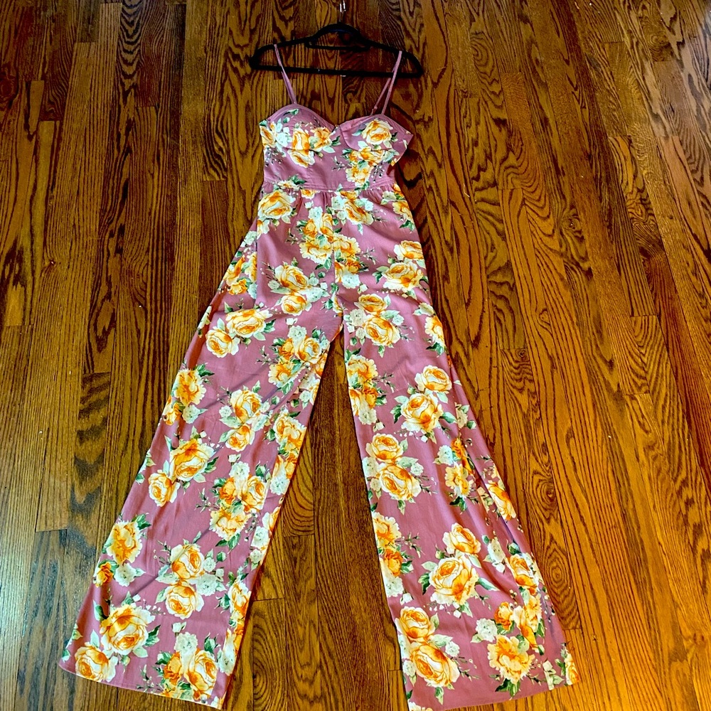 Never worn.  Floral trendy romper. Size small. Perfect for any occasion!